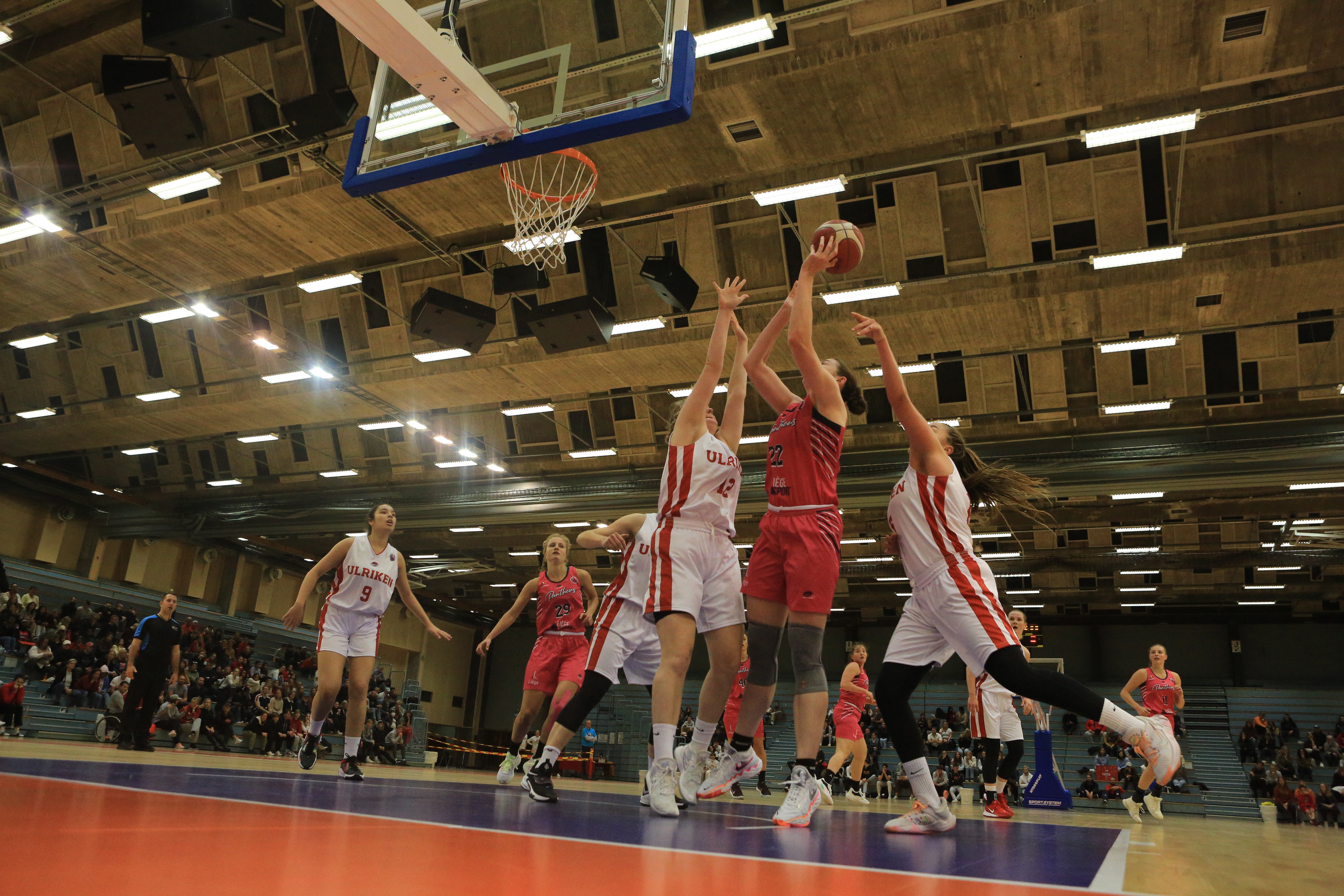 Ulriken-jentene fikk det vanskelig med å nå opp til Liège Panthers'  Brittany Brewer. Her scorer hun to av sine 27 poeng selv om Sunniva Sørbye (til venstre) og Karyn Sanford gjør det de kan for å forstyrre den 1,96 m lange amerikaneren. Til venstre i bildet ser vi Celine Klett.
FOTO: NICHOLAS NORENG 