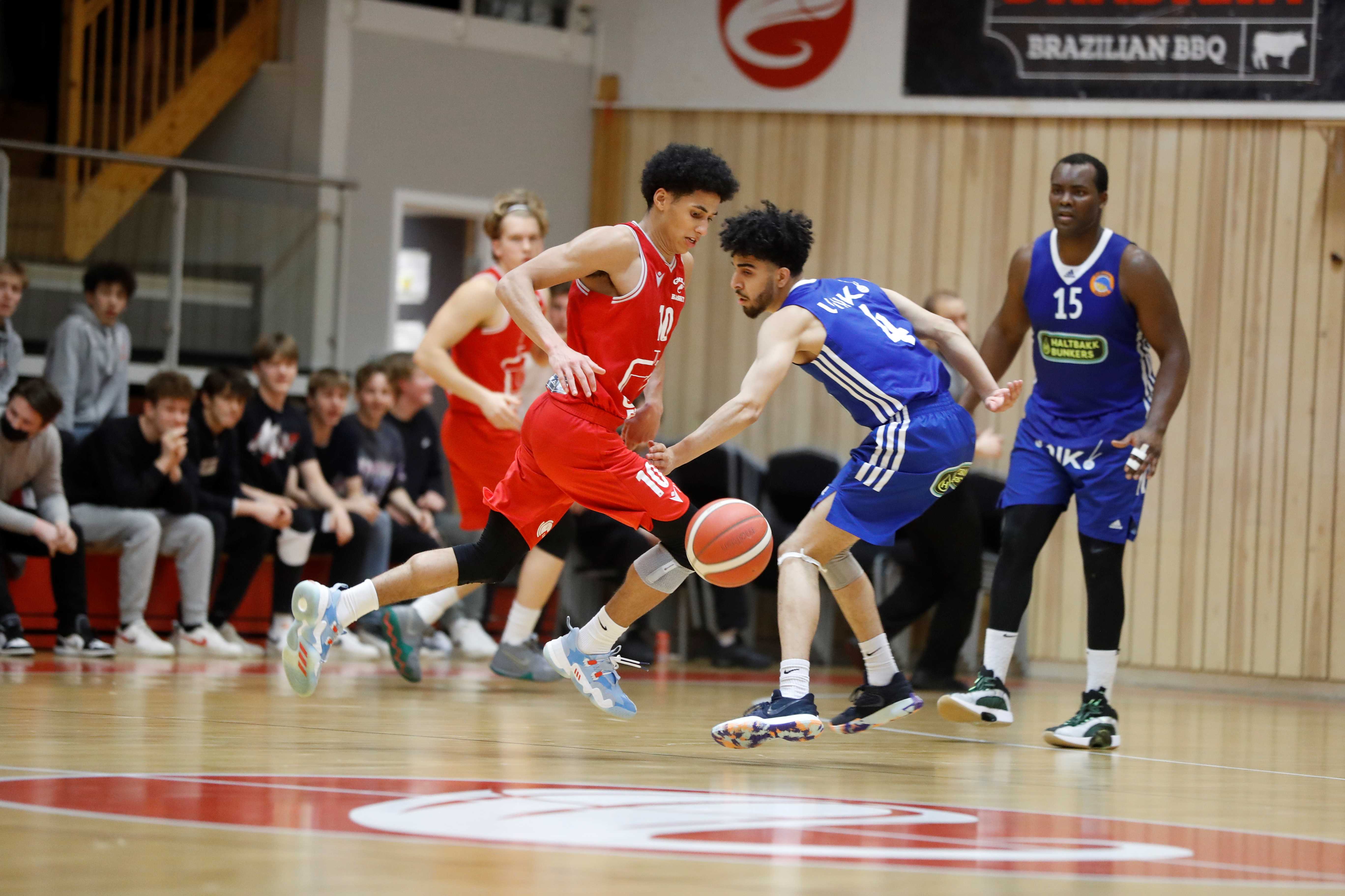 Lars Fredrik Espe tar ballen bak ryggen og lurer seg forbi Jasin Akil. Gimles pointguard storspilte mot Fyllingen og endte med en triple-double: 11 poeng, 13 assists og 10 returer. Til høyre med nummer 15 er Peter Bullock, bak til venstre ser vi Gard Beinnes. FOTO: NICHOLAS NORENG 